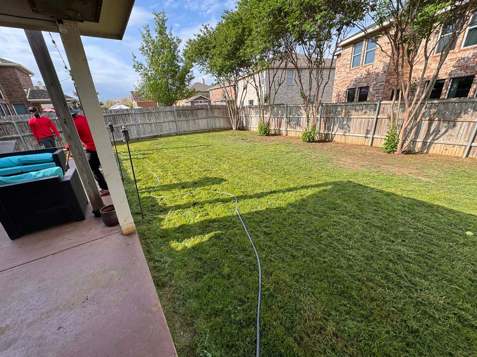 Same backyard freshly mowed and edged after HP Helpers service